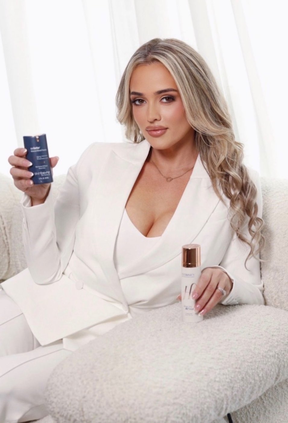 Michelle Valle holding her favorite Skinbetter Science and Hydrinity products