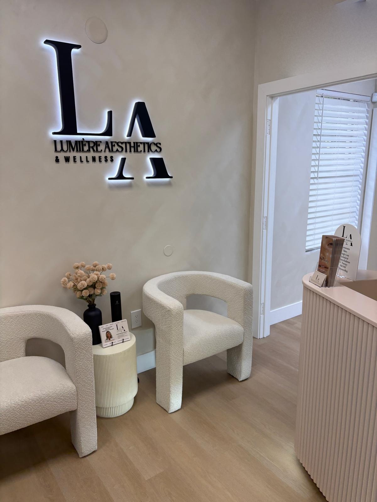 The Lumière waiting area — bouclé chairs and warm natural light